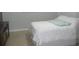 Bedroom with white bedding and light tile flooring at 6033 34Th W St # 45, Bradenton, FL 34210