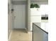 Kitchen and entrance featuring light colored ceramic tile, entry door, and white appliances at 6033 34Th W St # 45, Bradenton, FL 34210
