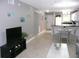 Living room, dining area, and kitchen featuring ceramic tile flooring and gray walls at 6033 34Th W St # 45, Bradenton, FL 34210