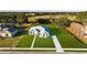 Aerial shot of home featuring a manicured lawn and stone walkway, set against a backdrop of lush surroundings at 10920 Flint Estates Dr, Thonotosassa, FL 33592