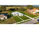 Overhead perspective of a home with a screened enclosure, landscaped yard, and inviting stone walkway at 10920 Flint Estates Dr, Thonotosassa, FL 33592