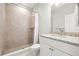Bright bathroom with a tiled walk-in shower and vanity with granite countertop at 10920 Flint Estates Dr, Thonotosassa, FL 33592