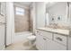 Bright bathroom with a shower-tub combo and vanity with granite countertop at 10920 Flint Estates Dr, Thonotosassa, FL 33592