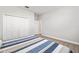 Bedroom featuring a bed with a striped quilt and a closet with white doors at 10920 Flint Estates Dr, Thonotosassa, FL 33592