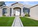 Welcoming front entrance with stone accents and a decorative walkway, enhancing the home's inviting curb appeal at 10920 Flint Estates Dr, Thonotosassa, FL 33592