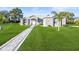 Beautiful single-story home with stone accents, manicured lawn, and a charming walkway leading to the front door at 10920 Flint Estates Dr, Thonotosassa, FL 33592