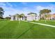 Charming home with a landscaped front yard, complemented by palm trees and a patterned walkway, offering curb appeal at 10920 Flint Estates Dr, Thonotosassa, FL 33592