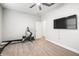 Home gym featuring a rowing machine and mounted TV at 10920 Flint Estates Dr, Thonotosassa, FL 33592