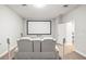 Bright home theater with a large screen and white leather seating at 10920 Flint Estates Dr, Thonotosassa, FL 33592