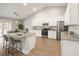 Bright, open kitchen with white cabinets, stainless steel appliances, and a granite-topped island at 10920 Flint Estates Dr, Thonotosassa, FL 33592
