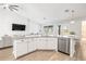 White kitchen island featuring granite countertops, stainless appliances and sink at 10920 Flint Estates Dr, Thonotosassa, FL 33592