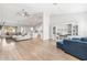 Spacious living room with ample seating and natural light, flowing into the kitchen and dining area at 10920 Flint Estates Dr, Thonotosassa, FL 33592