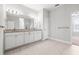 Bright bathroom with dual sinks, granite countertops, and ample cabinet space for storage and convenience at 10920 Flint Estates Dr, Thonotosassa, FL 33592