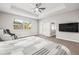 Comfortable main bedroom featuring a view of the exterior, ceiling fan, and flatscreen television at 10920 Flint Estates Dr, Thonotosassa, FL 33592