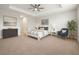 Serene main bedroom with tray ceilings, a ceiling fan, and neutral decor for a relaxing retreat at 10920 Flint Estates Dr, Thonotosassa, FL 33592