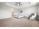 Relaxing main bedroom featuring a tray ceiling, ceiling fan, and comfortable bed, creating a peaceful atmosphere at 10920 Flint Estates Dr, Thonotosassa, FL 33592