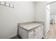 Convenient mud room featuring granite countertops, ample storage, and coat hooks for organization at 10920 Flint Estates Dr, Thonotosassa, FL 33592