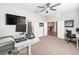 Bright office with a ceiling fan, desk, and modern computer setup at 10920 Flint Estates Dr, Thonotosassa, FL 33592