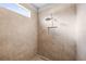 Modern tiled shower with a rainfall showerhead and a built-in niche for convenient storage at 10920 Flint Estates Dr, Thonotosassa, FL 33592