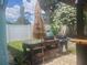 Backyard featuring an outdoor kitchen area, mature landscaping, and vinyl fence at 1279 Dinnerbell E Ln, Dunedin, FL 34698