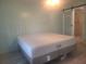 Bedroom featuring a queen-sized bed, closet with sliding door, and an ensuite bathroom with tiled shower at 1279 Dinnerbell E Ln, Dunedin, FL 34698