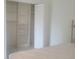 Large closet space with shelving for organization, a folding door, and tile flooring at 1279 Dinnerbell E Ln, Dunedin, FL 34698