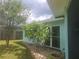A blue single Gathering home with mature landscaping and large windows at 1279 Dinnerbell E Ln, Dunedin, FL 34698