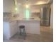 Bright kitchen featuring white cabinets, stainless steel appliances, marble countertops and a backsplash at 1279 Dinnerbell E Ln, Dunedin, FL 34698