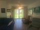 Comfortable living room with large window, ideal for relaxation and entertaining at 1279 Dinnerbell E Ln, Dunedin, FL 34698