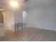 Neutral living room featuring light colored wood floors, white walls, and a closet for storage at 1279 Dinnerbell E Ln, Dunedin, FL 34698