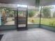 View from the screened lanai looking out at backyard with an outdoor bar and grill area at 1279 Dinnerbell E Ln, Dunedin, FL 34698
