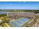Condominium complex offering tennis courts, parking, and waterfront views with scenic landscaping at 19451 Gulf Blvd # 204, Indian Shores, FL 33785