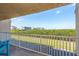 Relaxing condo balcony showcasing serene views of surrounding natural beauty and distant buildings at 19451 Gulf Blvd # 204, Indian Shores, FL 33785