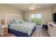 Bedroom with sliding door to patio offering views and plenty of light at 19451 Gulf Blvd # 204, Indian Shores, FL 33785