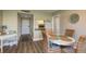 The dining area features a round table, four woven chairs, and a pass-through to the kitchen at 19451 Gulf Blvd # 204, Indian Shores, FL 33785