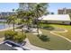Beautifully maintained condo grounds featuring lush landscaping, a tennis court, and walking paths at 19451 Gulf Blvd # 204, Indian Shores, FL 33785