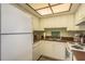 Bright kitchen with white appliances, offering a functional cooking space at 19451 Gulf Blvd # 204, Indian Shores, FL 33785