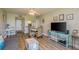 A cozy living room with a dining table, a mounted TV, and views into the kitchen area at 19451 Gulf Blvd # 204, Indian Shores, FL 33785