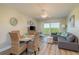 A cozy living room with a round dining table, sofa, and a slider that leads to a balcony at 19451 Gulf Blvd # 204, Indian Shores, FL 33785