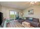 Relax in this living room with its plush couch, coastal decorations, and a large glass door leading to the outside at 19451 Gulf Blvd # 204, Indian Shores, FL 33785