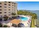 Condominium community featuring a large pool, jacuzzi and comfortable seating by the waterfront at 19451 Gulf Blvd # 204, Indian Shores, FL 33785