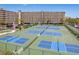 Multi-story condominium with tennis courts, lush landscaping, and parking at 19451 Gulf Blvd # 204, Indian Shores, FL 33785