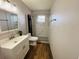 Bathroom featuring a single sink vanity with decorative lighting, a mirror, and a shower at 27064 Omni Ln, Punta Gorda, FL 33983