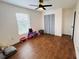 Bright bedroom featuring wood floors, a window, a closet, and neutral walls at 27064 Omni Ln, Punta Gorda, FL 33983
