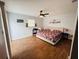 Spacious bedroom with wood floors, ceiling fan, and neutral walls at 27064 Omni Ln, Punta Gorda, FL 33983