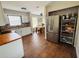 Spacious kitchen showcasing white cabinets, stylish backsplash, wood countertops, and stainless steel appliances at 27064 Omni Ln, Punta Gorda, FL 33983