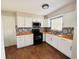 Updated kitchen featuring white cabinets, stylish backsplash, wood countertops, and stainless steel appliances at 27064 Omni Ln, Punta Gorda, FL 33983