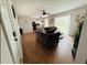 Open concept living room with wood-look tile, ceiling fan, and sliding glass doors to the backyard at 27064 Omni Ln, Punta Gorda, FL 33983
