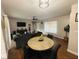 Comfortable living room with wood-look tile flooring and a dining table in the foreground at 27064 Omni Ln, Punta Gorda, FL 33983