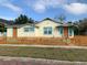 Charming bungalow with a colorful picket fence and vibrant trim, creating a welcoming curb appeal at 331 25Th S St, St Petersburg, FL 33712